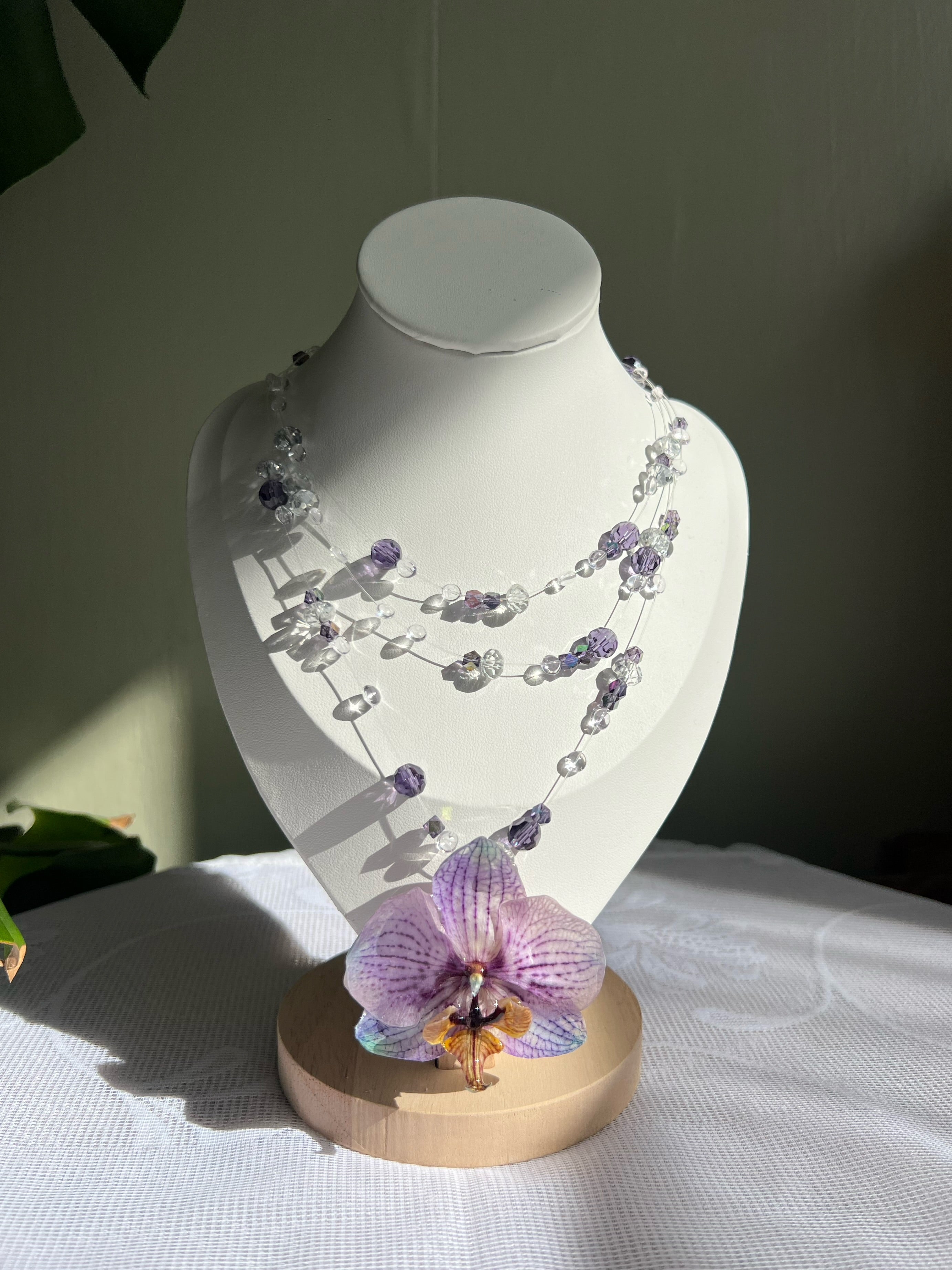 Ianthe multi-strand crystal necklace with preserved orchid pendant on display bust | smo studio