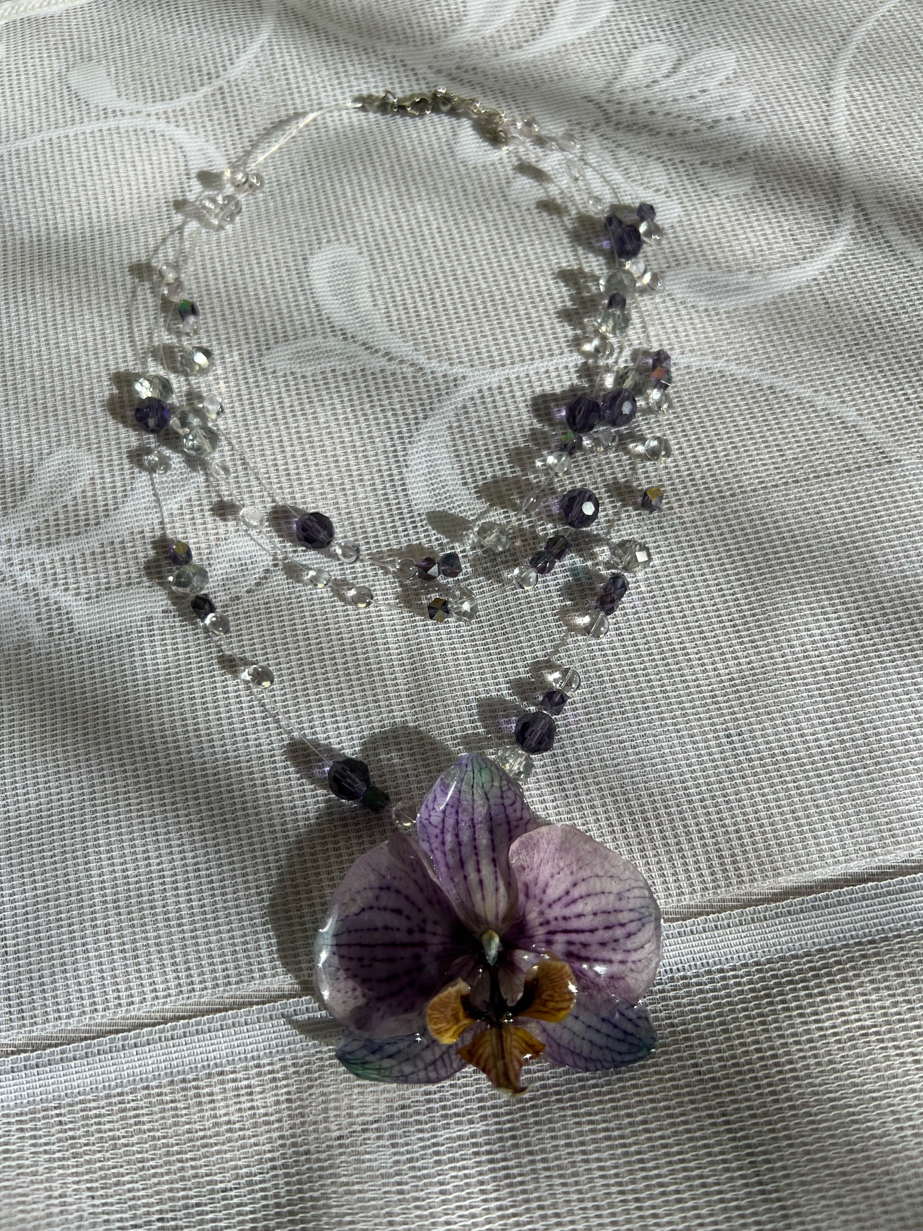 Ianthe preserved orchid pendant necklace flat lay — crystal and amethyst beaded chain | smo studio